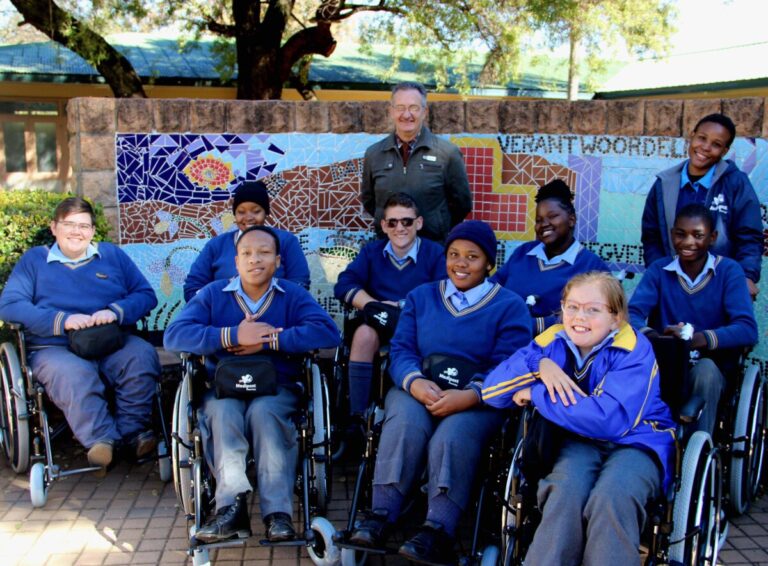 Meerhof School Principal, Kobus van der Merwe and some of the children who will use the wheelchairs Medipost Holdings recently donated to the school as part of its annual socioeconomic development initiatives.