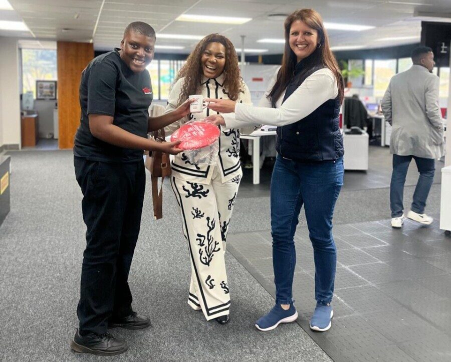 Retail Manager , Natasha Taylor poses with autism activist, Nkazimulo Mngomezulu and his mom,  Luleka Radebe