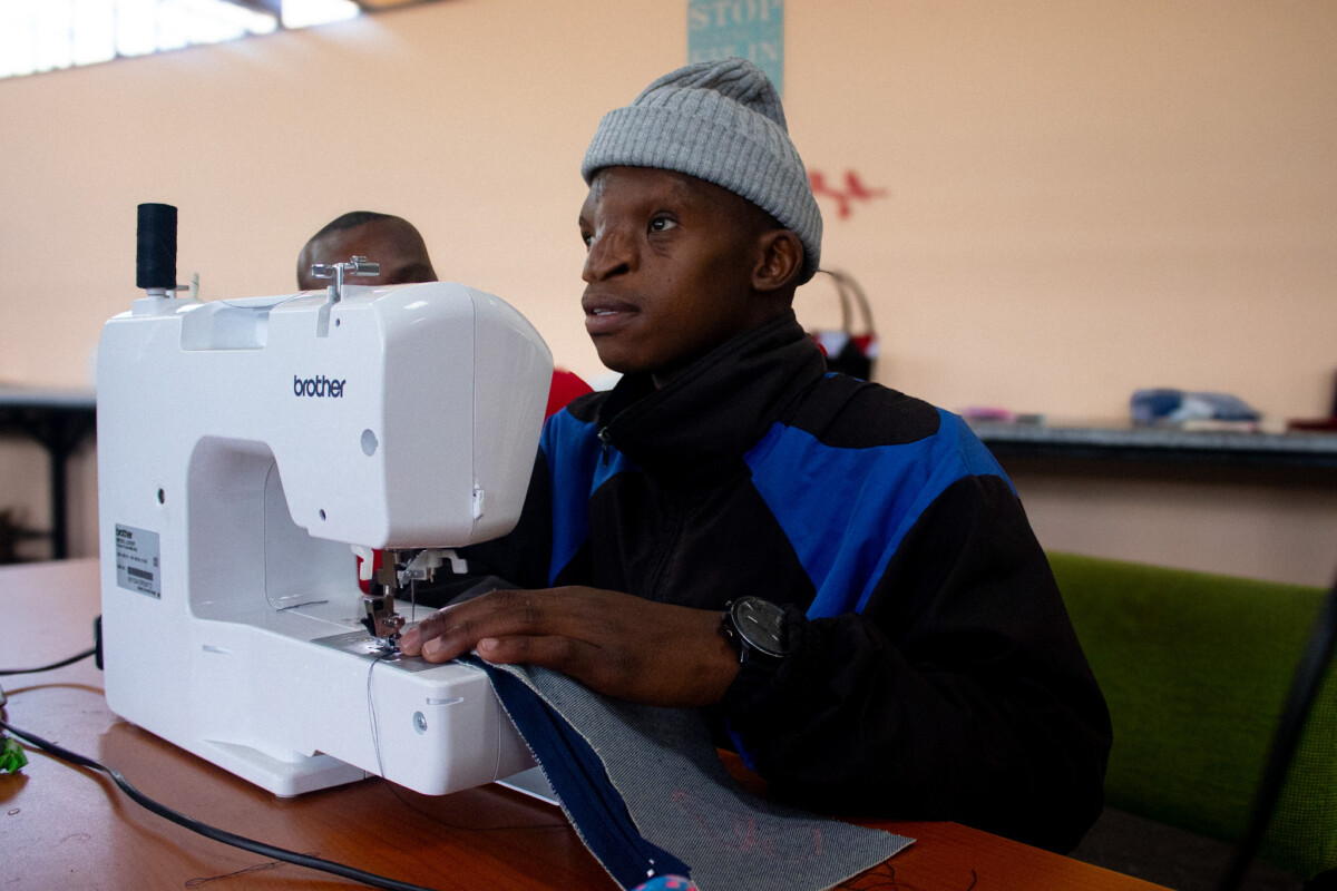 Siyavuya Mhlonyane now can use a sewing machine thanks to Kopano Workshop