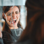 Shot of a young female having a mental breakdown at home. Support for Schizophrenia is essential