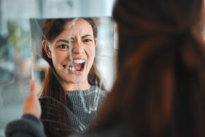 Shot of a young female having a mental breakdown at home. Support for Schizophrenia is essential