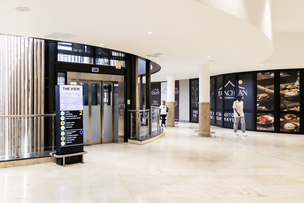 Lifts: "The lift lobby and directory sign at The View, Fourways Mall." Workshop17 coming soon