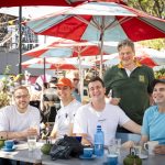 Café: "Friends laughing around a café table under red and white umbrellas in Hazelwood."Workshop17 coming soon